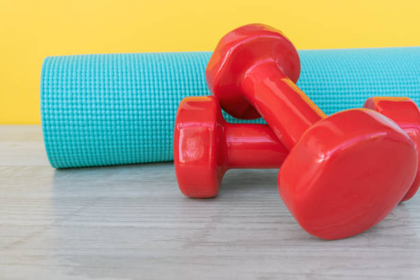 istock Yoga mat and pink dumbbell 1217874753