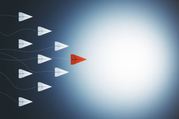 istock Abstract red and white paper planes flying 1217875412