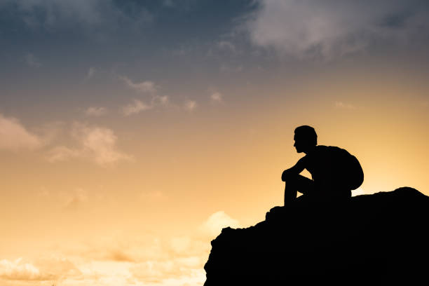 istock Man hiker enjoying beautiful sunset 1217875434