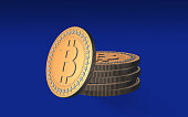 Bitcoin Coins are Piled Together Against Blue Background
