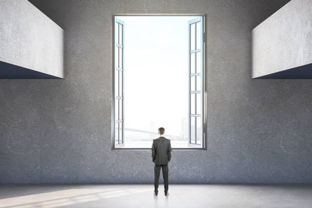 istock Businessman standing in modern living room 1217875722