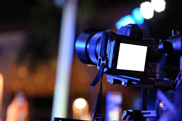 Professional videographer with camera on gimbal stabilizer for taking production
