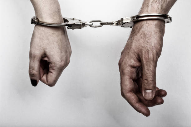 istock men and women cuffed hands together 1217875873
