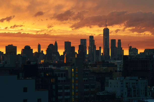istock New York Lower Manhattan sunset skyline view from Brooklyn with dramatic sky and clouds over roofs 1217878710