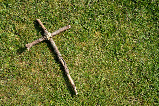 istock Wooden cross laid on the grass 1217878758