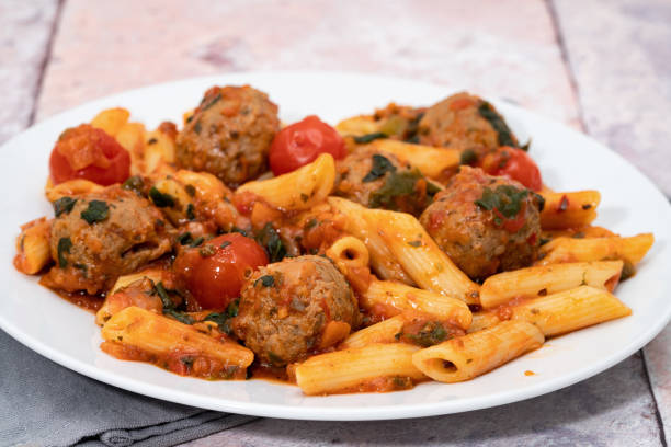Pasta with meatballs in tomato sauce Penne pasta with meatballs in tomato sauce penne meatballs stock pictures, royalty-free photos & images