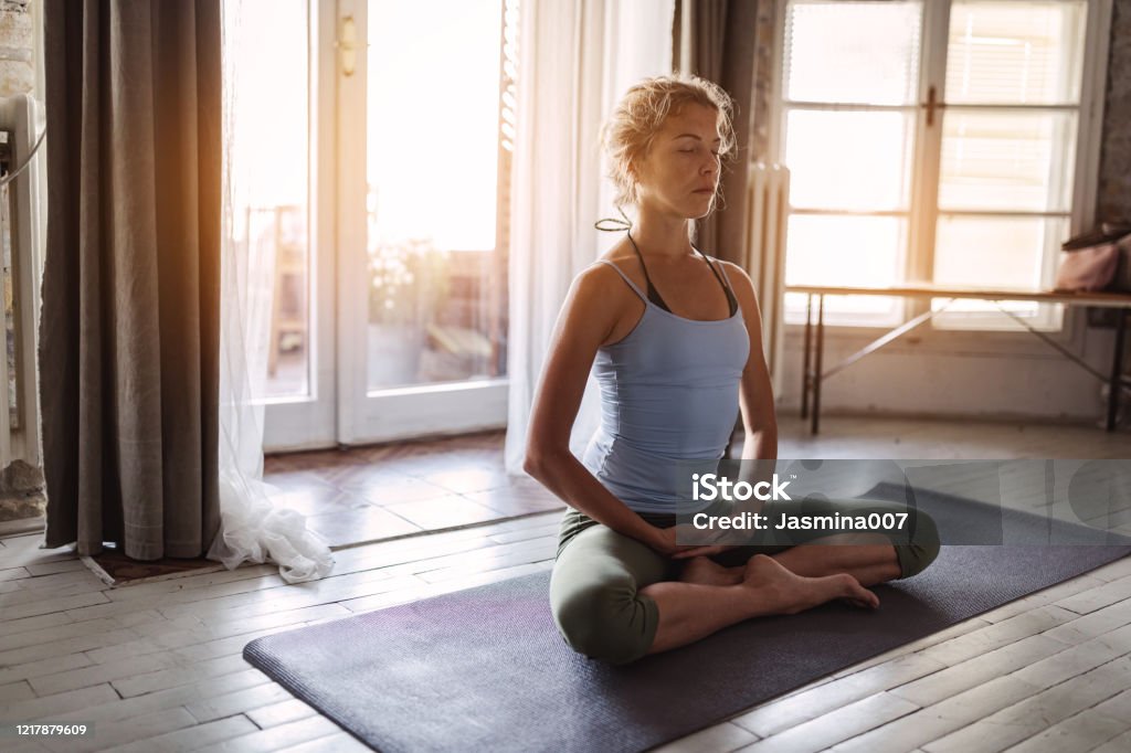 Young sporty woman practicing yoga Yoga Stock Photo