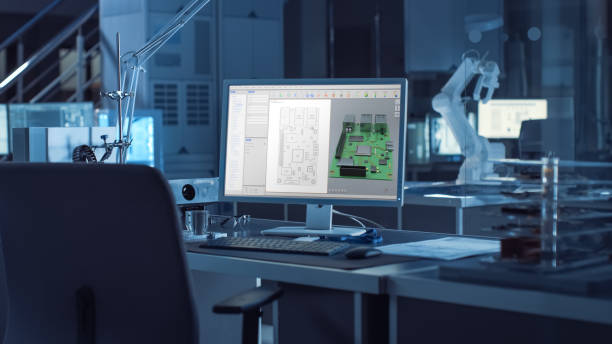 istock On the Desk Computer With CAD Software and Design of 3D Industrial Machinery Component. In the Background Robot Arm Concept Standing in Heavy Dark. Industry Engineering Facility. 1217883724