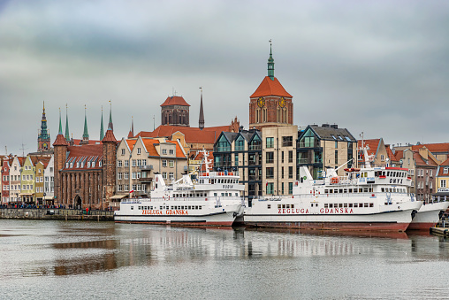 Gdansk, Poland – Feb 14, 2019: View at historic houses along Motlawa river and touris boats in the old historic town of the Gdansk city in Poland.