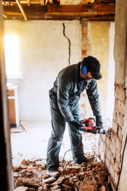 istock working man damaging wall in house 1217884561