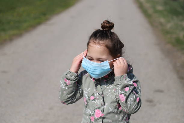 istock Little girl wearing pollution mask 1217886046