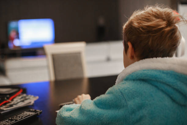 istock Rear view of student in completing homeschooling task during lockdown 1217886944