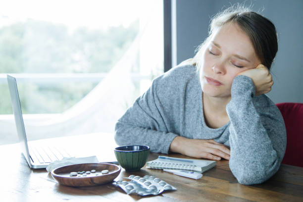 istock Tired sick woman with closed eyes relaxing after working on PC 1217887237