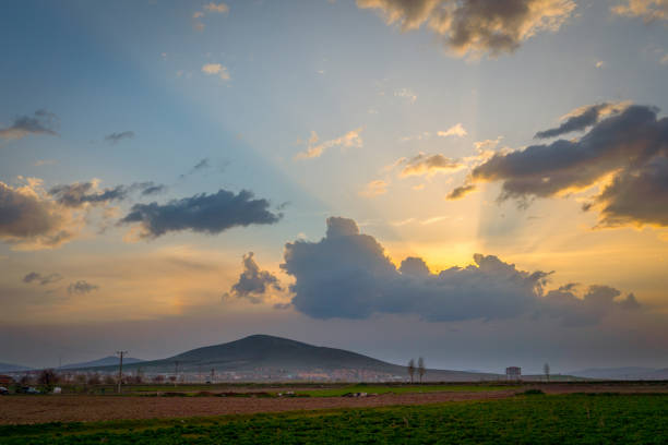 Dramatic black and red clouds with sunbeam over adacal hill at sunset, Emirdag, Afyonkarahisar, Turkey