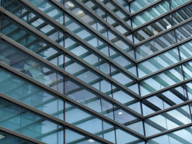 istock a full frame modern office architecture abstract with angular steel geometric shapes and buildings reflected in blue glass windows 1217893306
