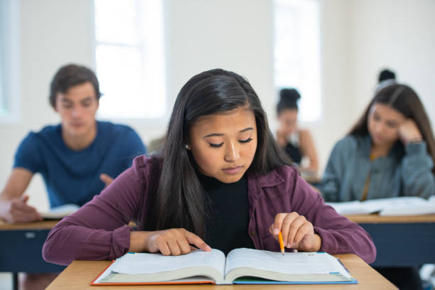 istock Multi-ethnic young woman studying in classroom 1217894348