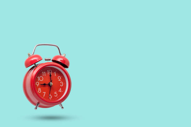 istock Red alarm retro clock on blue background. 1217895106