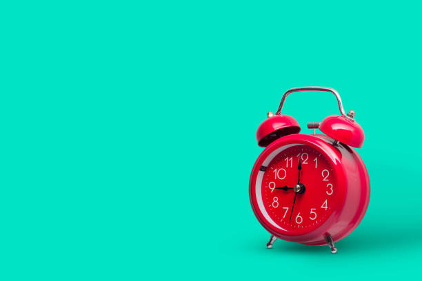 istock Yellow alarm retro clock on yellow background. 1217895108