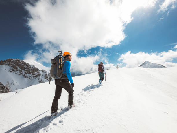 istock Two people hiking on a sunny winter day 1217897359