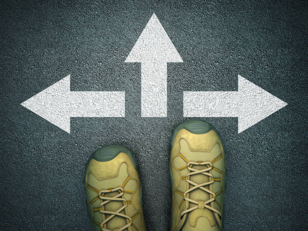 istock Feet on Asphalt Road with Arrows - 3D Rendering 1217898514