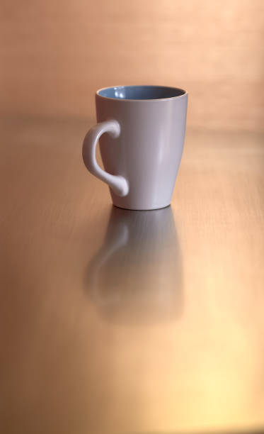 istock front view of a white cup on a metallic background 1217903602