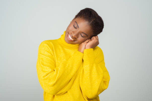 istock Peaceful black woman enjoying yellow sweater 1217904344