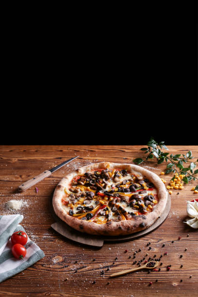 whole italian pizza on wooden table with ingredients - pepperoni pizza green olive italian cuisine tomato sauce imagens e fotografias de stock