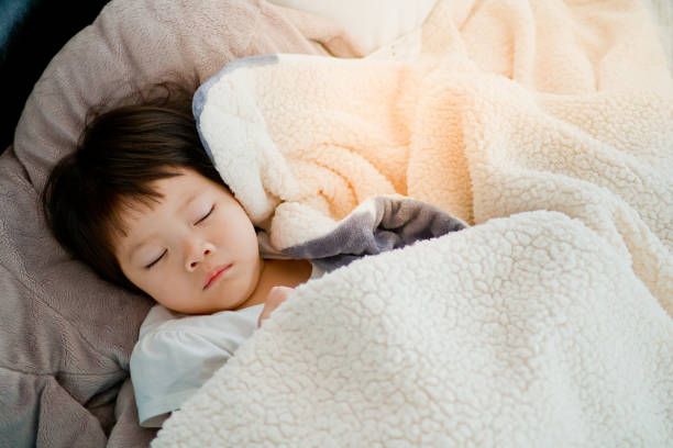 istock asian girl sleep on bed 1217907116