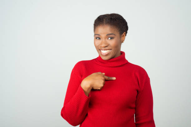 istock Happy positive black woman pointing finger at herself 1217908065