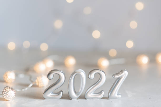 istock New Year 2021 silver balloons with fireworks 1217909387
