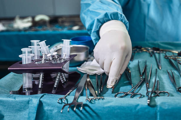 istock Hands Holding Syringe and Transfer Fat with Nano Fat Transfer Tool in Operation Room 1217913389