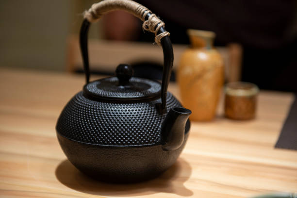 istock Japanese traditional black iron flat round teapot 1217915970