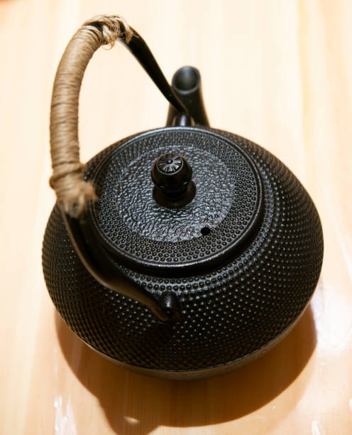 istock Japanese traditional black iron flat round teapot 1217915978