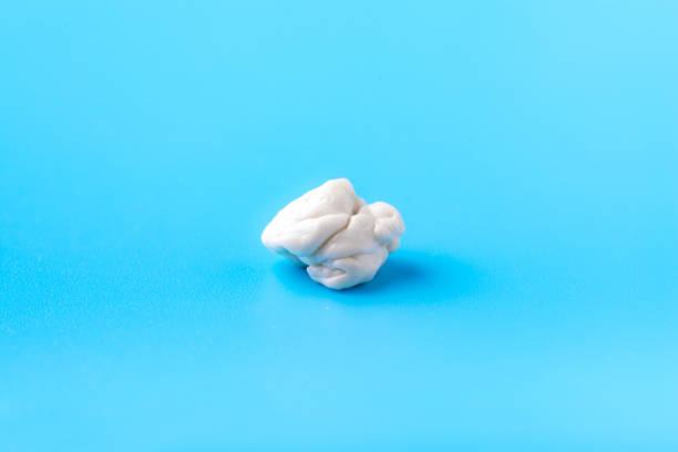 Chewed chewing gum on a blue background. Bad gum. Close up. Macro mode. Beautiful photo