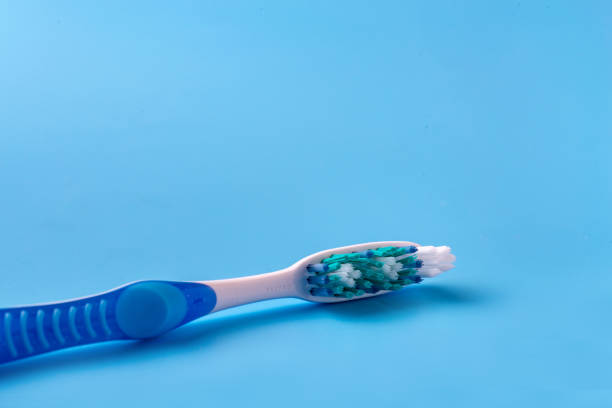 istock Blue toothbrush on a blue background. The view from the top 1217918514