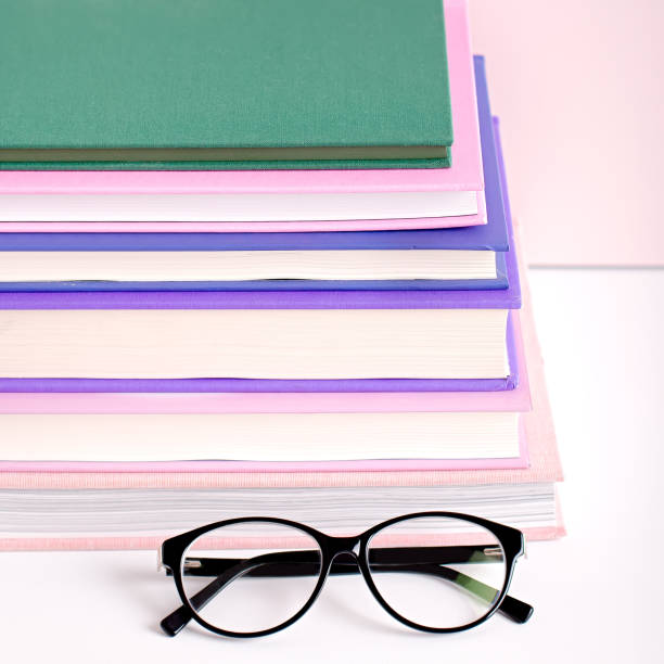 istock Books stack, eyeglasses, house plants succulents and fragrant candle and sticks. Background for World Book Day. Still life with stack of colorful books and home interior decor 1217921097