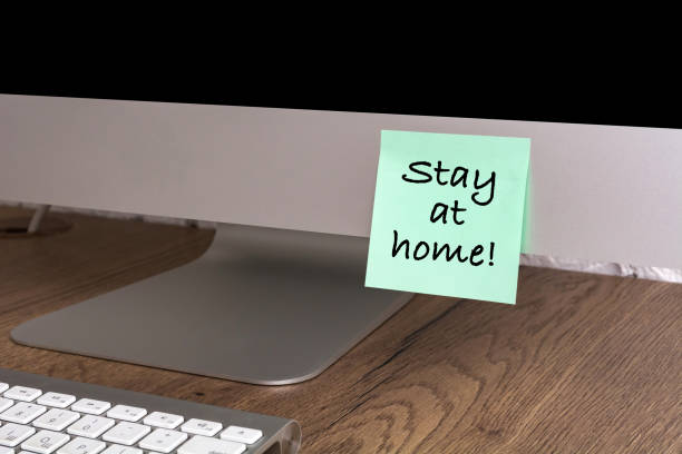 istock Computer with a sticker with the text Stay at home. Concept about quarantine and remote work. 1217922286