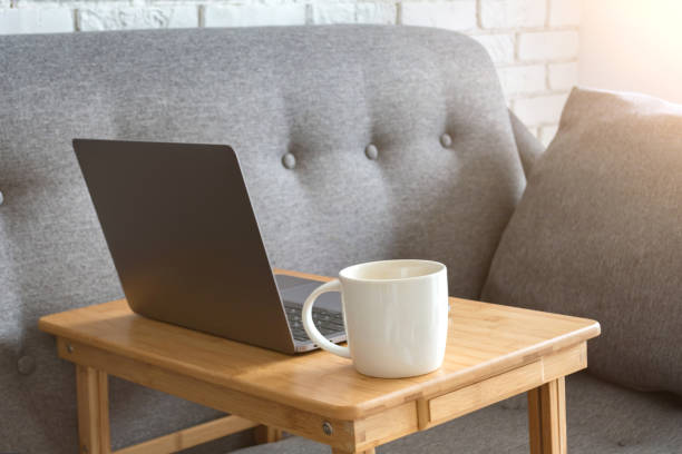 istock Work from home. Cozy workplace for remote work and business online. Sofa with a laptop. Quarantine, coronavirus concept. 1217922329
