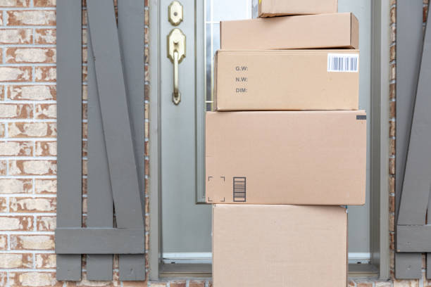 istock Pile of Freshly delivered Boxes being left outside at front door 1217926669