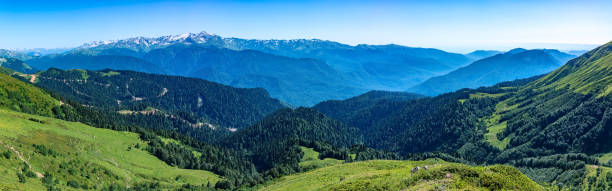 istock Panoramic view over the Green Valley, surrounded by high mountains with snow on a clear summer day. 1217928375