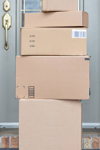 istock Pile of Freshly delivered Boxes being left outside at front door 1217928639