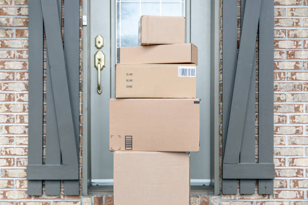 istock Pile of Freshly delivered Boxes being left outside at front door 1217928653
