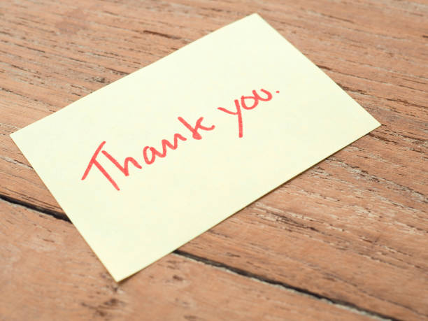 istock Thank you for handwriting on post-it notes on a wooden background. 1217932712