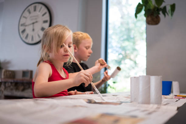 istock Brother and sister doing a homeschooling project 1217935956