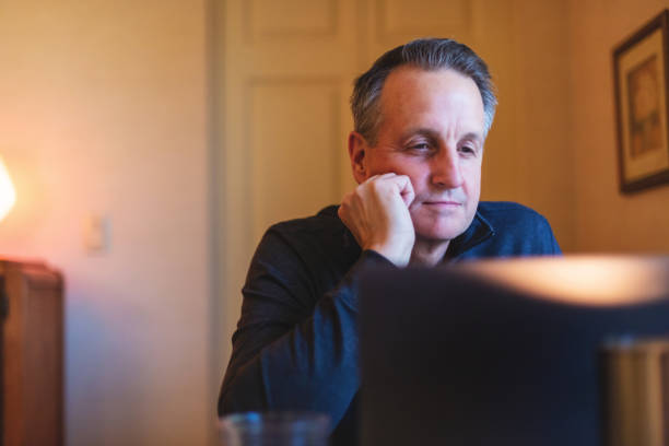 istock Mature Adult Male Using and Experiencing Laptop Technology Working from Home Image Series 1217937383