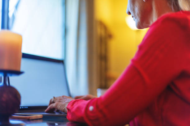 istock Mature Adult Female Using and Experiencing Laptop Technology Working from Home Image Series 1217937807