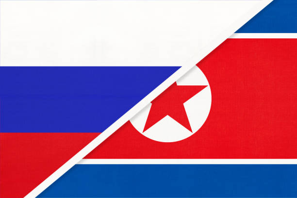 istock Russia vs North Korea national flag from textile. Relationship and partnership between two countries. 1217939582