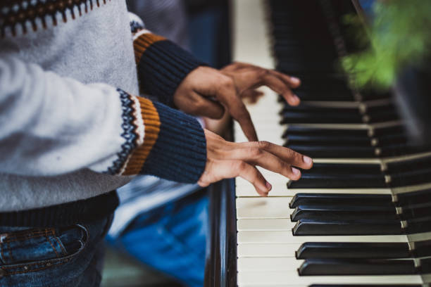 istock Close up of unrecognizable black child playing a piano. 1217943245