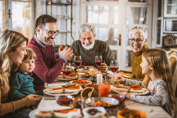 istock Happy extended family talking during lunch at dining table. 1217943465