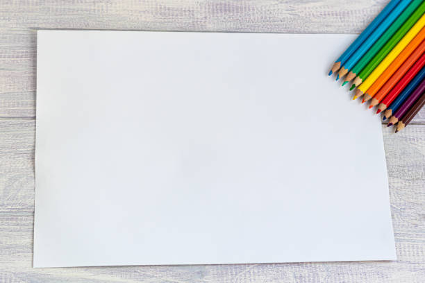 istock Handmade crafts. Creative activity for children on vacation and in quarantine. Colored paper, scissors and a pencil. The project of children's creativity, needlework. 1217944455